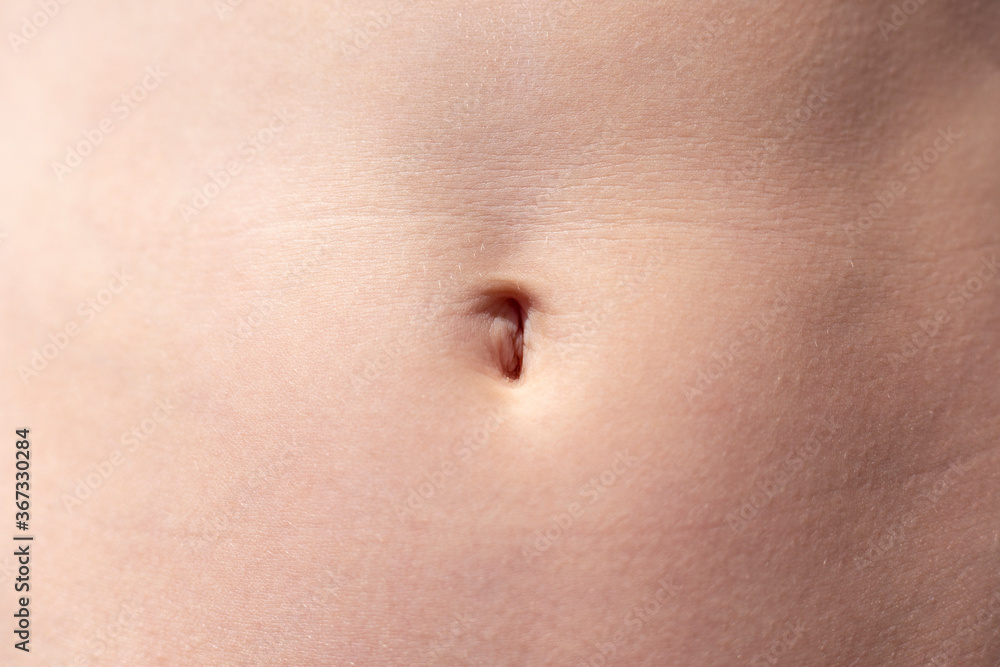 Navel of a teenage girl, front view close-up