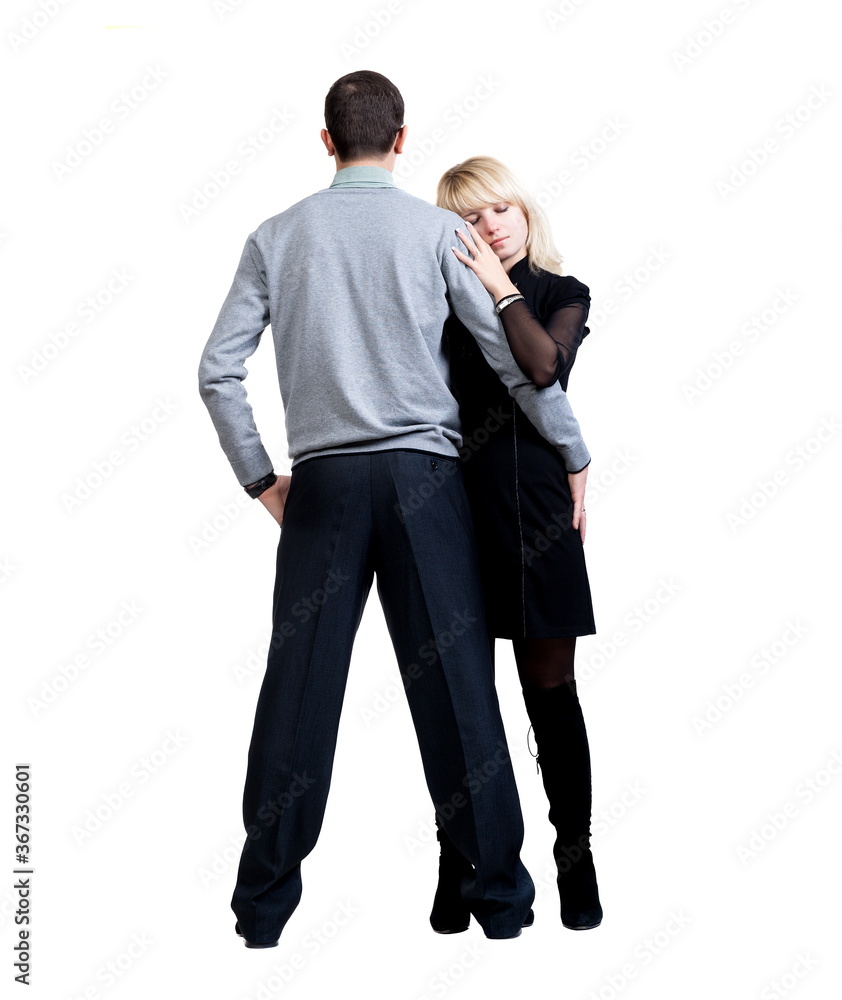 Couple, a young man and a beautiful blond woman posing on a white background, isolated Couple, a young man and a beautiful blond woman posing on a white background, isolated
