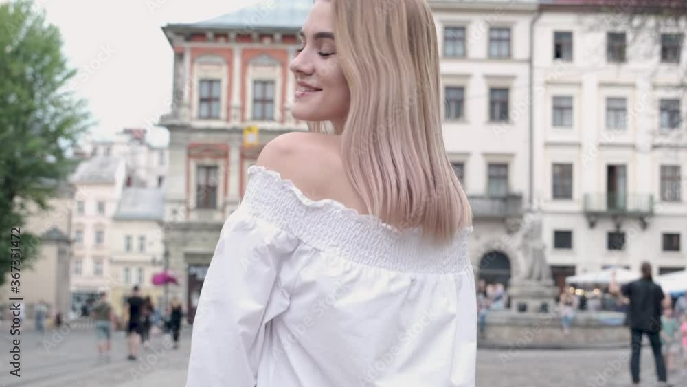 Beautiful girl fashion portrait with white dress walking on the street on old city. Pretty young woman in a white dress close up slow motion 4k. Beautiful girl fashion portrait with white dress walking on the street on old city. Pretty young woman in a white dress close up slow motion 4k.
