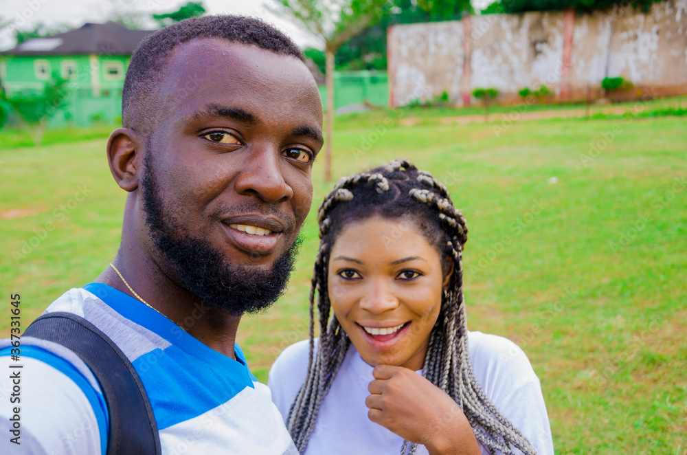 Fototapeta premium two cute african couples feeling excited as they are taking selfie with their smartphone