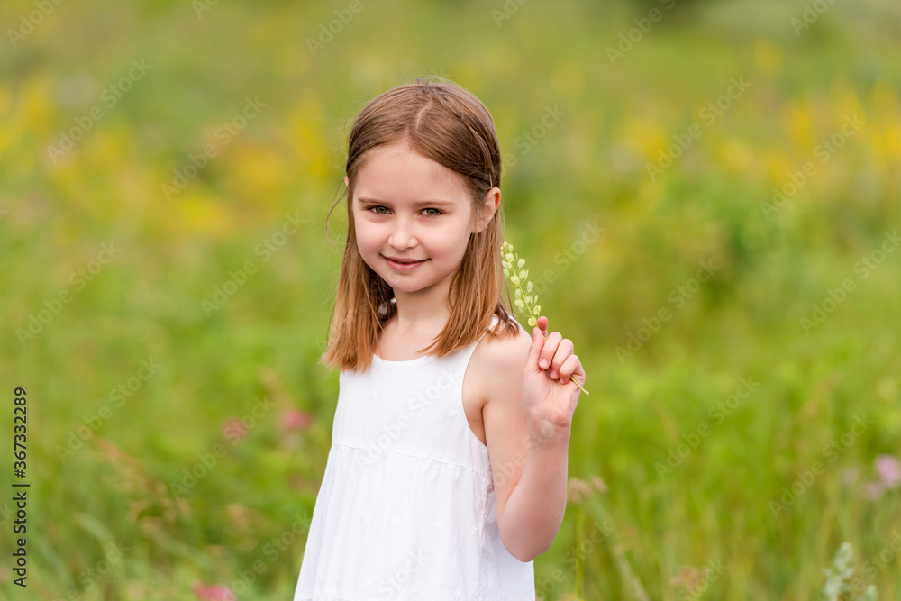 Cute little girl holding wildflower bouquet Cute little girl holding wildflower bouquet