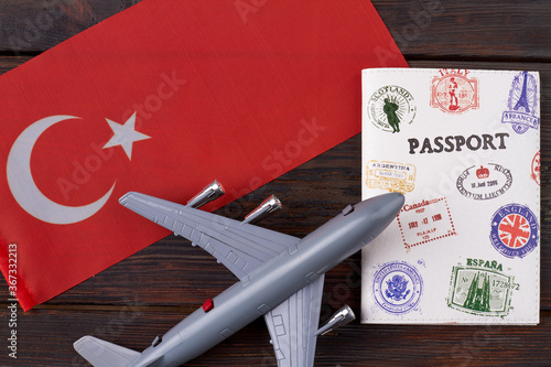 Turkey traveling concept. Composition pf toy airplane, passport and turkish flag on wooden table. Top view flat lay.