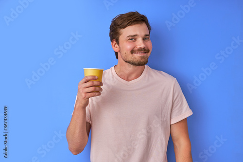 cheerful man with cup of tea n hands  man drink hot tea and feel happy isolated on colourful background