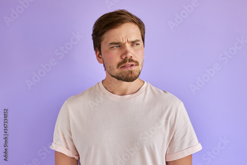 portrait of puzzled and confused man with beard in casual wear, thoughtful, not knowing what is wrong. human feeling, emotions, face expressions