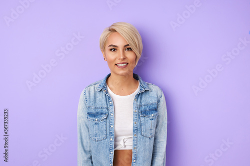portrait of caucasian short-haired trendy woman smiling at camera, cheerful lady has perfect toothy smile