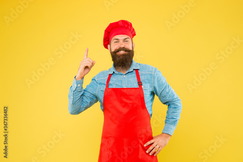 Explore great tasting food. special offer from chef. chef in restaurant kitchen. mature male chef on yellow backdrop. man cooking on kitchen. Professional chef with idea. excellent cook or baker