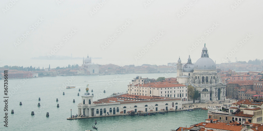 Fototapeta premium Panorama view from San Marco campanile on Venice Grand Canal, Basilica di Santa Maria della Salute in cloudy weather, Italy