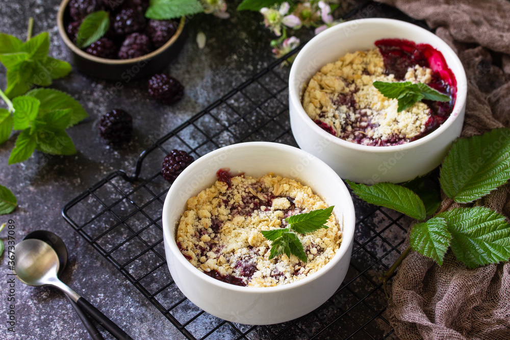 Homemade summer dessert. Blackberry crumble in baking dish on a stone countertop. Homemade summer dessert. Blackberry crumble in baking dish on a stone countertop.