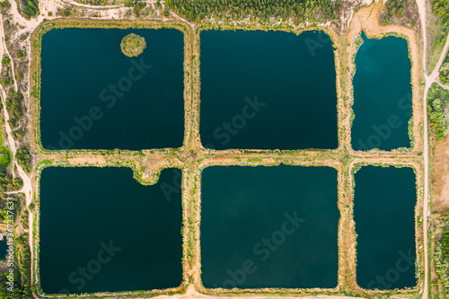 Aerial View Retention Basins, Wet Pond, Wet Detention Basin Or Stormwater Management Pond, Is An Artificial Pond With Vegetation Around The Perimeter, And Includes A Permanent Pool Of Water In Its photo