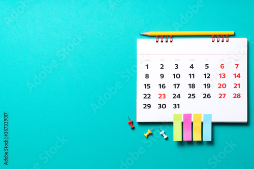 close up of calendar on the green table background, planning for business meeting or travel planning concept photo