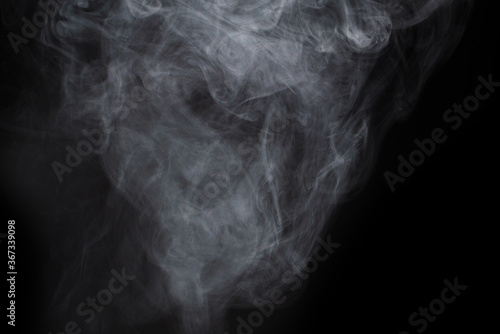 Fototapeta Naklejka Na Ścianę i Meble -  White steam on a black background.