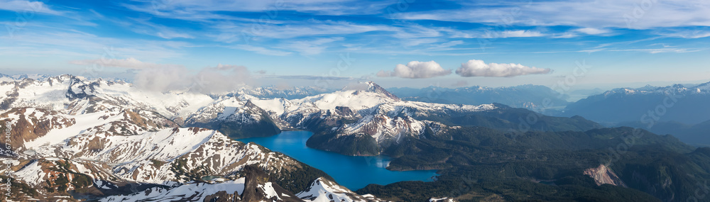 Aerial Panoramic View of Garibaldi surrounded by Beautiful Canadian Mountain Landscape during a sunny and cloudy day. Taken near Squamish and Whistler, North of Vancouver, British Columbia, Canada.