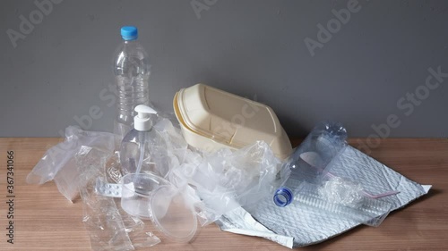 household plastic waste - stop motion animation - heap of domestic plastic trash such as bottles bags containers and packaging material photo