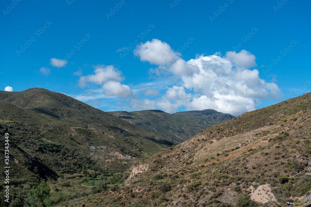 mountainous area and sky with clouds