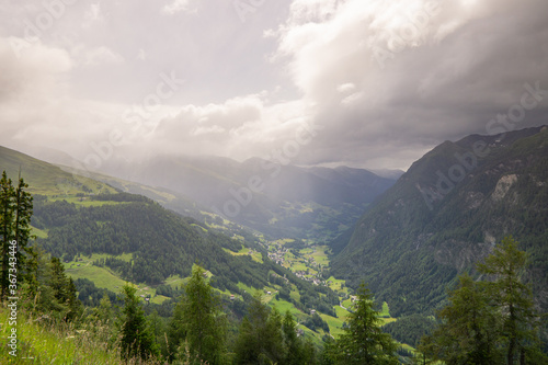 cloudy mountains in Austria with trees in the foreground