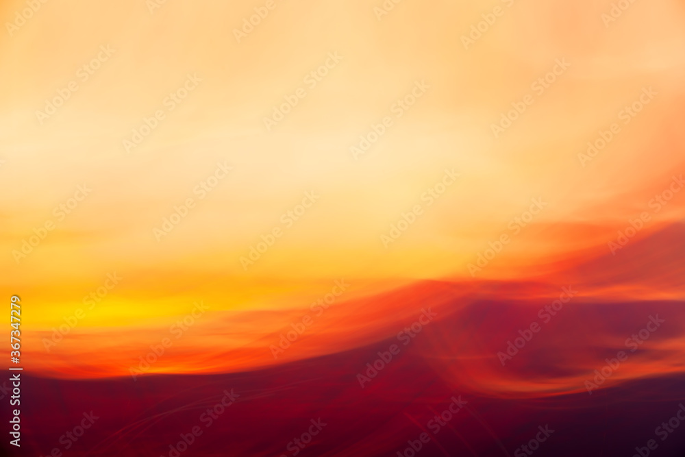 Red-yellow clouds on sunset shooted with camera motion. Abstract background