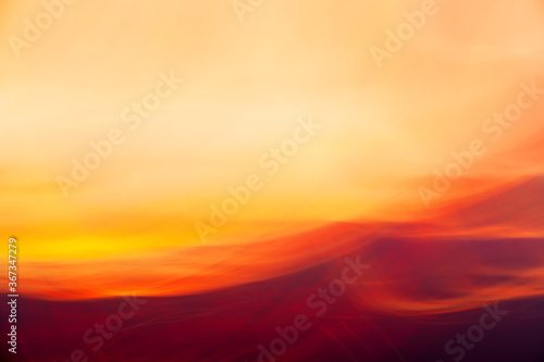 Red-yellow clouds on sunset shooted with camera motion. Abstract background © IuriiA
