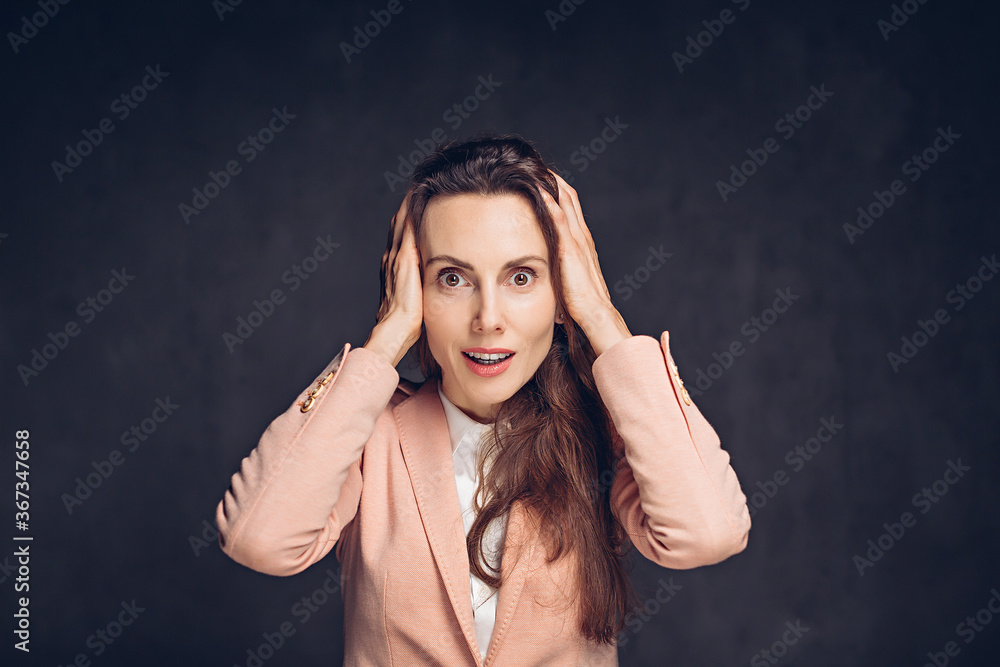 Shocked adult caucasian woman on dark background