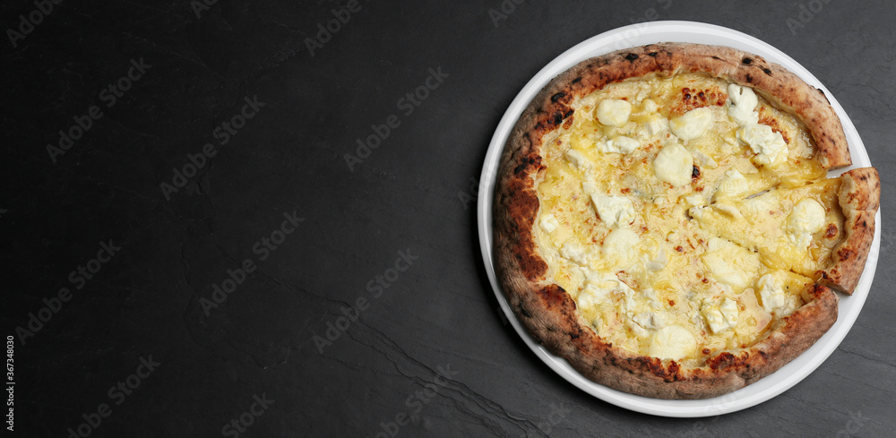 Top view of hot delicious pizza on dark table, space for text. Banner design Top view of hot delicious pizza on dark table, space for text. Banner design