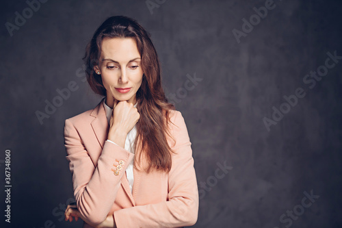 Depressed adult caucasian woman on dark background