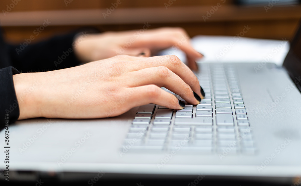 Businesswoman typing on laptop at workplace Businesswoman typing on laptop at workplace
