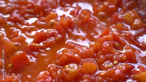 Tomato sauce. .Pan Left. Close up. Slow motion..Boiling tomato sauce made from chopped fresh ripe tomatoes..Italian cuisine.