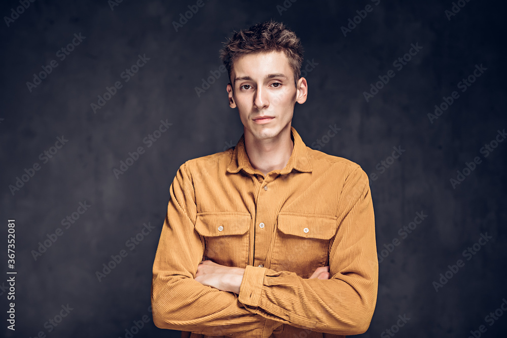 caucasian man with crossed arms on dark background caucasian man with crossed arms on dark background