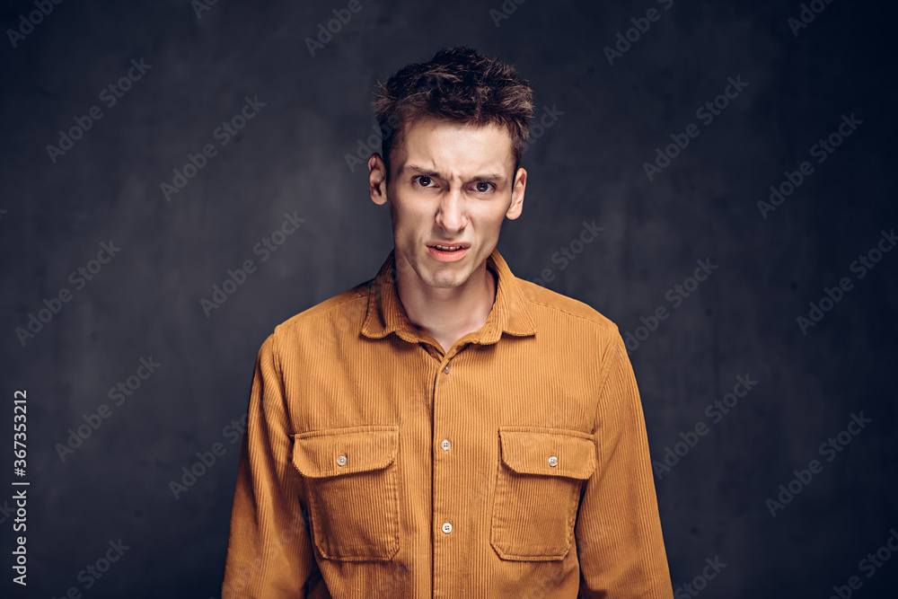 Dissatisfied caucasian man on dark background Dissatisfied caucasian man on dark background