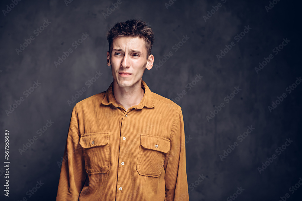 caucasian man with headache on dark background