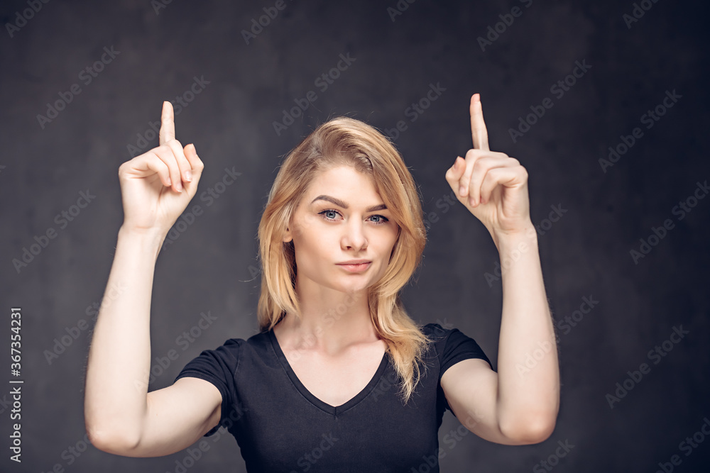 young caucasian girl have idea on dark background young caucasian girl have idea on dark background