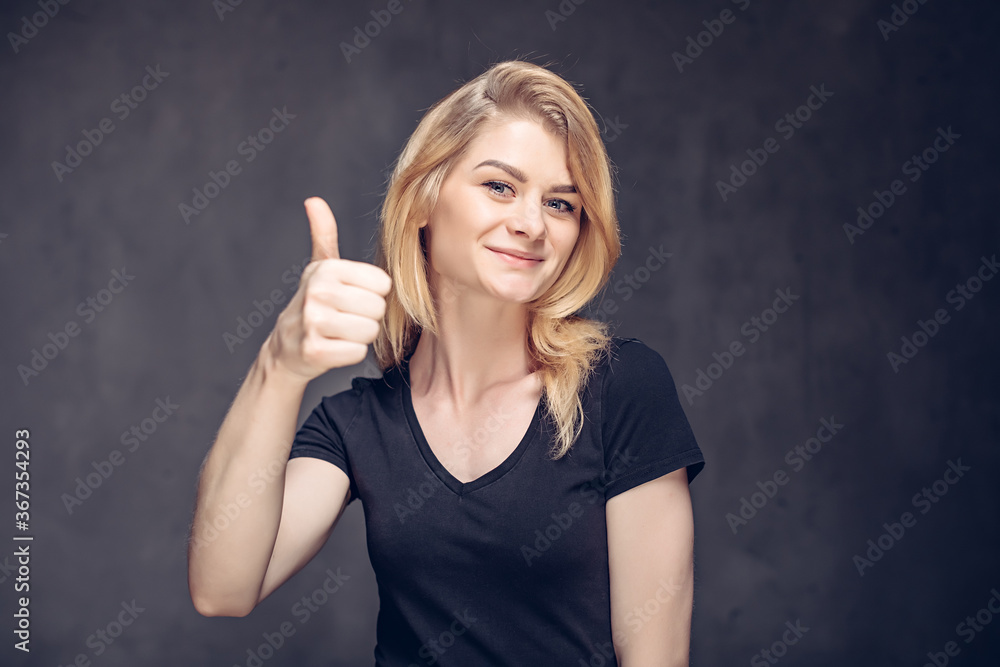 caucasian girl show thumb up on dark background caucasian girl show thumb up on dark background