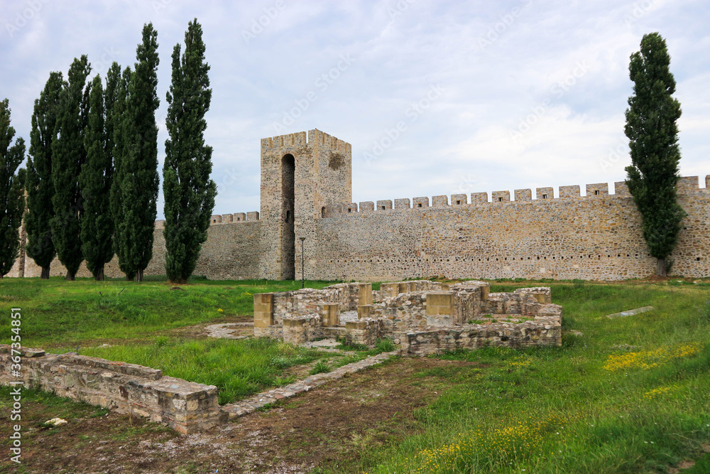 view to inner yard and ruined outer wall and towers of stone old medieval fortress Smederevo in Serbia, national landmark 