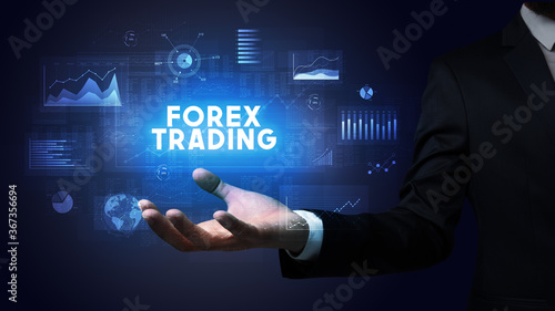 Hand of Businessman holding FOREX TRADING inscription, business success concept