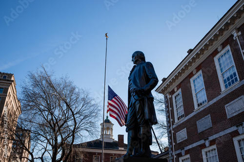 Statue of Benjamin Franklin and the United States flag