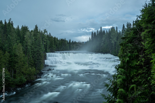 River in Wells Gray Porvincial Park with trees and moody clouds. 