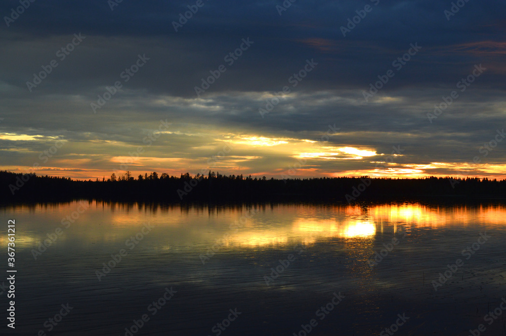 Finnish summer night. Lake and sunset. Fading light, strong colors. Blue and yellow.