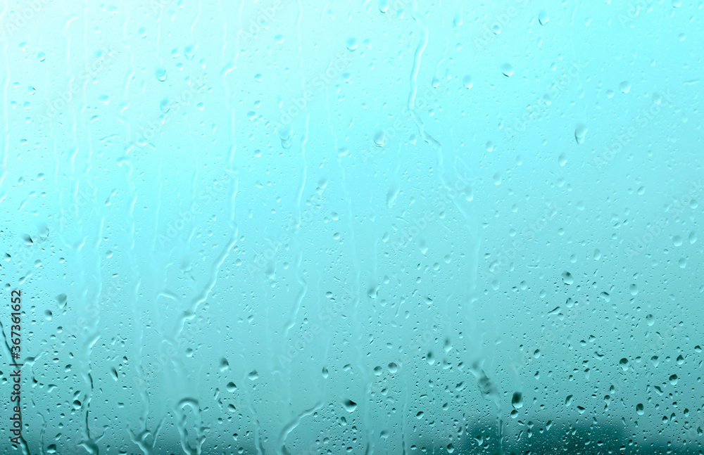 Raindrops on the window during a downpour. Water drops on the glass. Raindrops on the window during a downpour. Water drops on the glass.