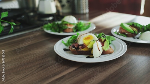 Bruschettas with Salmon, Avocado, cottage cheese and Poached Egg on the table