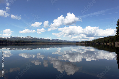 Fototapeta Naklejka Na Ścianę i Meble -  Lake scene in Montana with reflections of dynamic blue skies with clouds