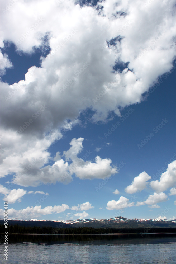 Lake scene in Montana with reflections of dynamic blue skies with clouds Lake scene in Montana with reflections of dynamic blue skies with clouds