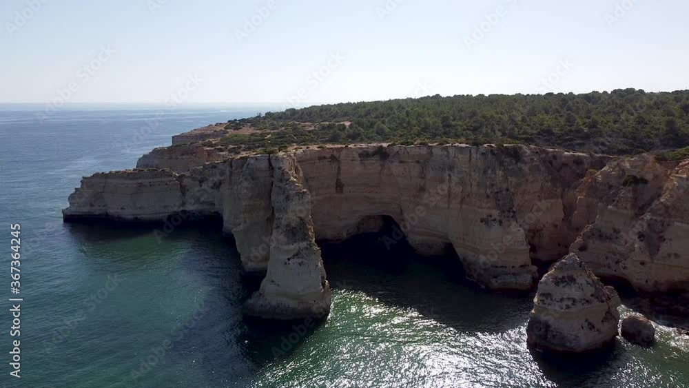Beautiful drone aerial view of the rocks and cliffs in the southern region of Portugal. Algarve is one of the most touristic and scenic place in Portugal with his blue ocean and amazing landscapes. Beautiful drone aerial view of the rocks and cliffs in the southern region of Portugal. Algarve is one of the most touristic and scenic place in Portugal with his blue ocean and amazing landscapes.