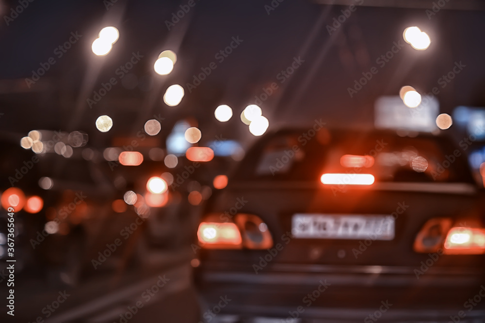 traffic of cars in the night city, view from the car, lights abstract auto background