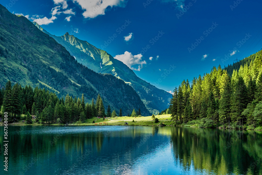 Beautiful lake Hintersee and green mountains and forest in austria in the summer.