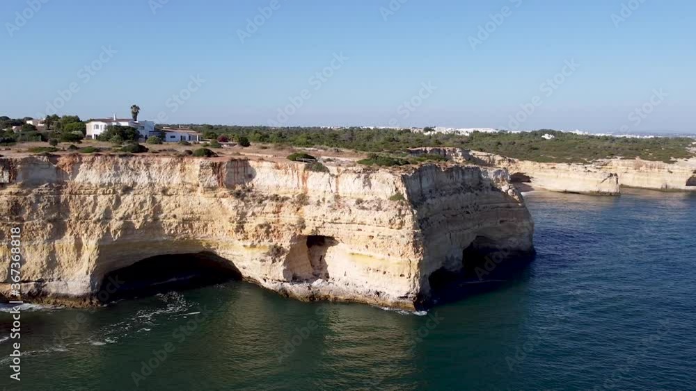 Beautiful drone aerial view of the rocks and cliffs in the southern region of Portugal. Algarve is one of the most touristic and scenic place in Portugal with his blue ocean and amazing landscapes. Beautiful drone aerial view of the rocks and cliffs in the southern region of Portugal. Algarve is one of the most touristic and scenic place in Portugal with his blue ocean and amazing landscapes.
