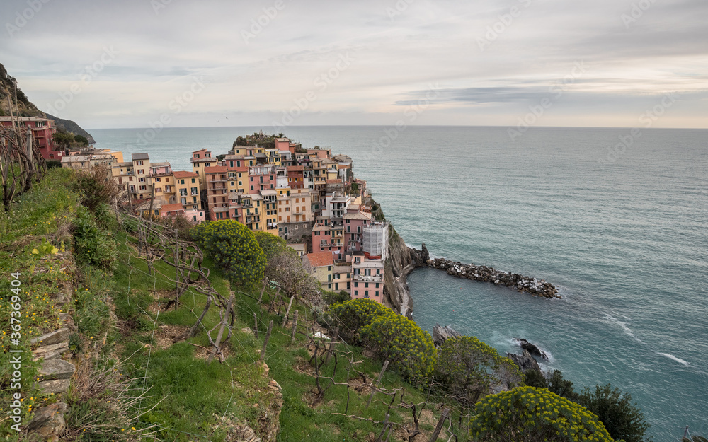 Cinque Terre villages along Ligurian rugged coast, view of its houses built on the cliff above the sea, La Spezia province, Liguria region, Italy.