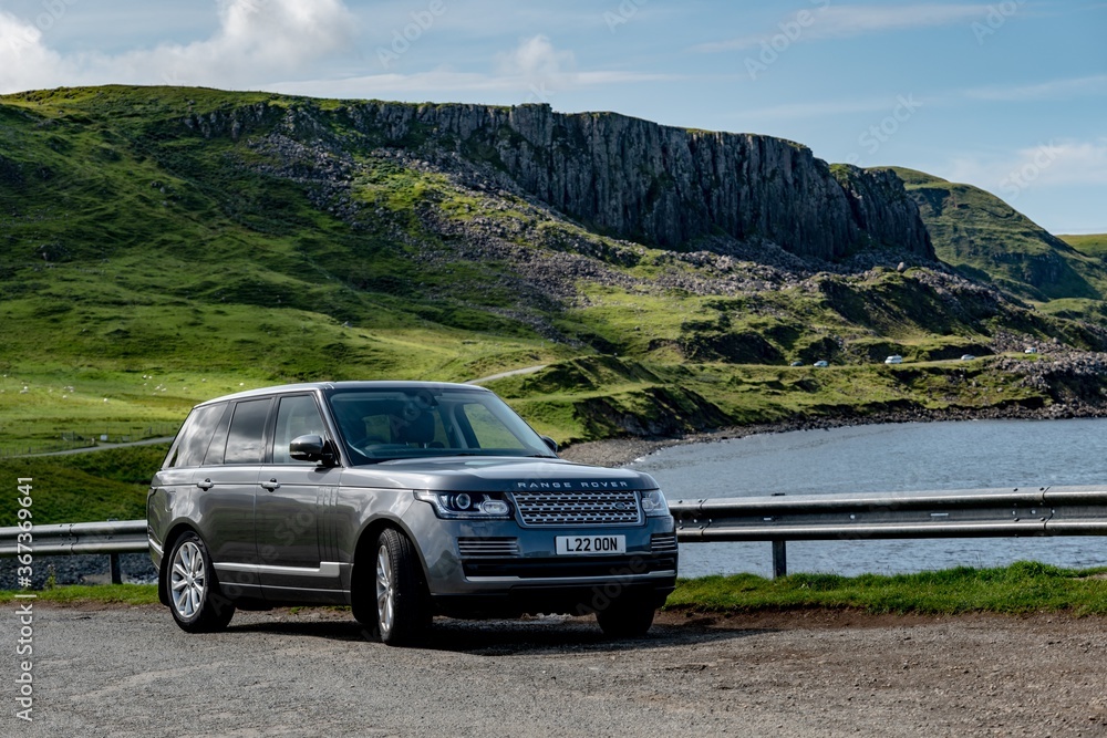 The legendary Range Rover L405 Type SUV parked in a beautiful nature near  Duntulm Castle in Scotland Photos | Adobe Stock