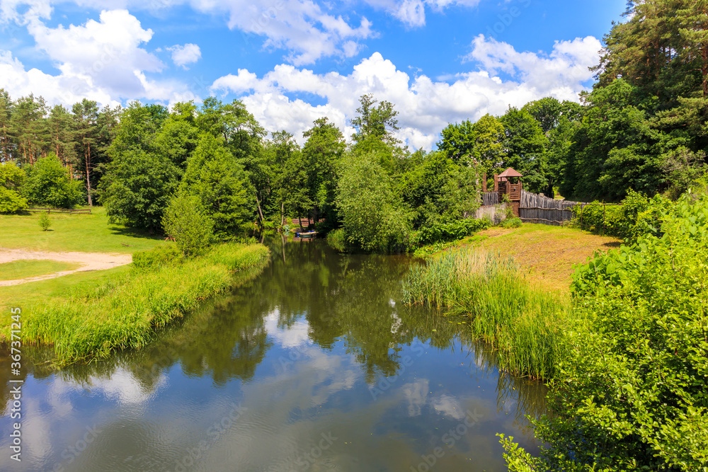 View of Krutynia river in Iznota village near Beldany lake on sunny summer day, Mazury Lake District, Poland