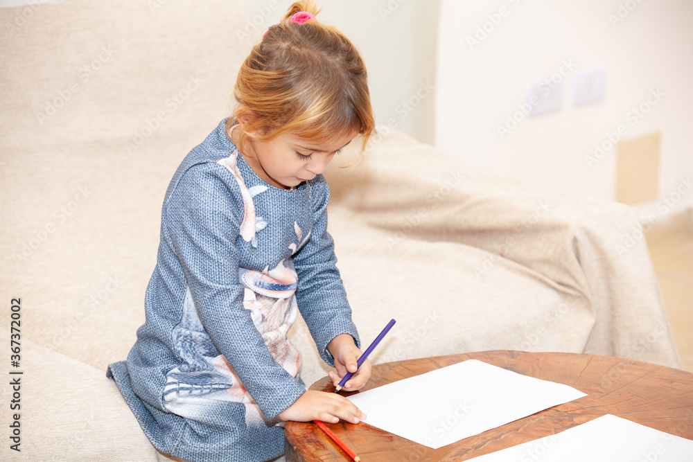 girl drawing on a wooden table girl drawing on a wooden table