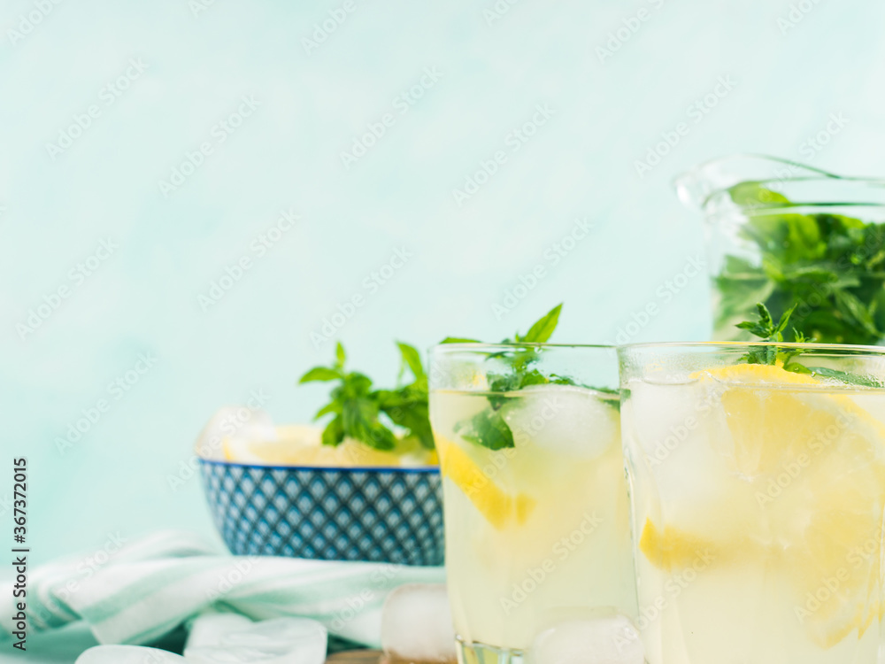 Fresh lemon lemonade in jug and glasses Fresh lemon lemonade in jug and glasses
