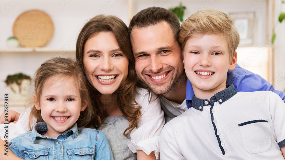 Cute Family Smiling Posing Sitting On Sofa At Home, Panorama Cute Family Smiling Posing Sitting On Sofa At Home, Panorama